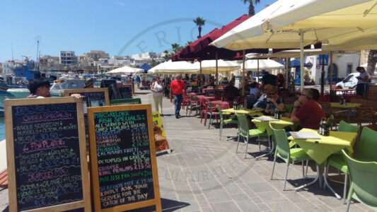 Marsaxlokk, Malta. Eating seafood is one of the main reasons for visiting Marsaxlokk. Both locals and tourist like spending time at the restaurants and bars located at the waterfront area while enjoying the view of the bay or how the fishermen work (Photo: Jordi Vegas Macias).