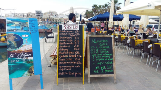 Marsaxlokk, Malta. Eating seafood is one of the main reasons for visiting Marsaxlokk. Both locals and tourist like spending time at the restaurants and bars located at the waterfront area while enjoying the view of the bay or how the fishermen work (Photo: Jordi Vegas Macias).